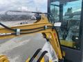 2024 AGT Industrial H13R Mini Excavator with a yellow arm attachment and bubble wrap on the controls and cab