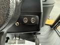 Close-up of the control panel of a 2011 John Deere 310SJ 4x4 Wheel Loader showing directional buttons for the extended hoe