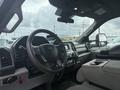 Interior view of a 2021 Ford F600 showing the steering wheel dashboard and center console