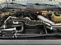 Engine compartment of a 2016 Ford F-550 with visible components including hoses wires and a large air intake system