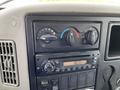 Dashboard controls of a 2014 International Durastar including temperature dials a CD player and various buttons