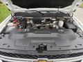 A 2013 Chevrolet Silverado 3500HD truck's engine compartment with the hood raised showcasing the engine and various components