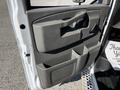 The interior door panel of a 2019 Chevrolet Express showing storage compartments and a door handle