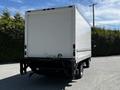 A 2018 Hino 195 box truck with a white exterior and a flatbed at the rear