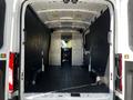 Interior view of a 2022 Ford Transit van showcasing a spacious cargo area with black walls and a flat floor