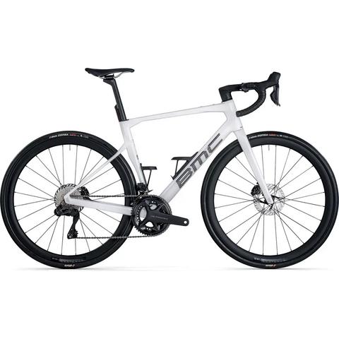 A white and gray 2026 BMC Roadmachine 01 FOUR road bike featuring a sleek frame disc brakes and an advanced gear system
