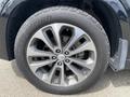 A close-up view of a 2015 Kia Sorento wheel with a silver alloy rim and a rugged all-terrain tire