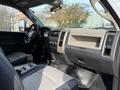 Interior view of a 2012 Dodge Ram 5500 featuring a wide dashboard with controls and a gear shift along with cloth seats in a two-tone color scheme