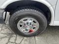 A close-up of a chrome wheel rim on a tire featuring the Chevrolet logo with a tread pattern visible on the rubber surface