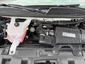 The engine compartment of a 2019 Chevrolet Express showing the engine components and coolant reservoir