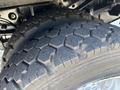 Close-up of the rugged tires of a 2016 Ford F-550 showcasing deep treads designed for durability and traction on various surfaces