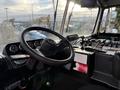 Interior view of a 2010 Autocar Xpeditor featuring a large steering wheel dashboard with gauges and control levers in the foreground