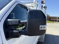 Close-up of the side mirror on a 2024 Ford F-550 Super Duty showcasing a black housing and integrated turn signal light