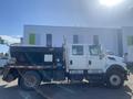 A side view of a 2014 International 7400 truck with a black dump bed and silver detailing and a compact cab
