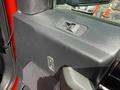 Close-up of the interior door panel of a 2019 Ford F-150 featuring a window control button a door lock button and a speaker grille