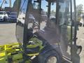 A 2010 Kubota F3990 with an enclosed cab features a black leather seat and a control panel visible inside the cabin