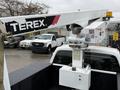 A 2012 Ford F-450 Super Duty truck with a Terex articulating boom lift mounted on the bed