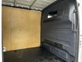 Interior view of a 2020 Mercedes-Benz Sprinter van showing a wooden wall and a grey panel with ventilation openings