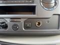 Close-up of the control panel in a 2023 Ford E-450 featuring buttons for TCS, USB ports, and audio settings