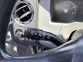 A black control stalk for windshield wipers and headlights on a 2015 Ford F-750 dashboard