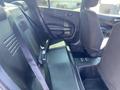 The image shows the rear interior of a 2019 Dodge Charger with black cloth seats and seatbelts visible on the bench seat