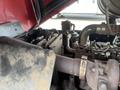 Close-up of the engine compartment of a 2014 Toro Groundmaster 5910 showcasing various mechanical components including pipes and an air intake system