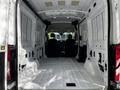 Interior of a 2021 Ford Transit van showing a spacious cargo area with bare metal walls and a smooth floor