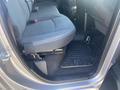 Interior view of the backseat of a 2021 RAM 1500 featuring black fabric seats and a rubber floor mat