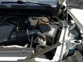 Interior view of the engine compartment of a 2021 Chevrolet Silverado 1500 showcasing the engine components and fluid reservoirs