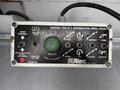 Control panel for a 2006 Ford F-450 aerial device featuring various buttons and switches for operational control