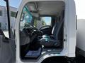 The interior of a 2007 GMC W3500 displaying the driver's seat, steering wheel, and dashboard with a view of the side mirrors and window