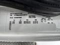 A label from a 2013 International DuraStar displaying manufacturing details including VIN and specifications for tire and rim sizes