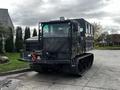 A 2023 Prinoth Panther T6 tracked utility vehicle featuring a large cabin with windows and a robust chassis designed for off-road use