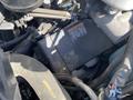 Close-up of a 2020 Chevrolet Express engine compartment showing wires and components including a black electrical box with a warning label