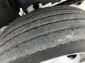 Close-up of a worn tire from a 2006 GMC C5000 showing visible tread wear and surface dust