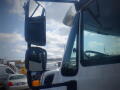 A 2016 International WorkStar 7500 truck's side mirror and window are prominently displayed with the cab visible