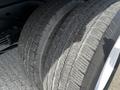 Close-up of two tires from a 2013 Ford Econoline showing tread patterns and sidewalls