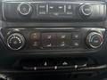 Dashboard controls of a 2016 GMC Sierra 1500 featuring air conditioning climate controls and media buttons