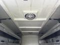 Interior view of a 2017 Ford F-150 truck bed with metal rails and a dome light mounted on the ceiling