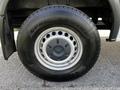 A close-up of a silver wheel from a 2017 Mercedes-Benz Sprinter featuring a black tire with the text Open Country and a circular metal rim design