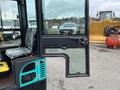 2024 AGT Industrial Green QH13R Mini Excavator with a partially open door and visible interior features including a seat and control panel