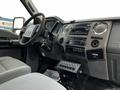 Interior view of a 2016 Ford F-550 featuring a steering wheel dashboard control panel and a gear shift along with several buttons and dials