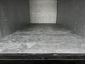 A 2013 Hino 195 truck with an empty cargo area featuring a flat wooden floor and walls lined with gray material