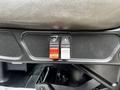Two buttons on the dashboard of a 2012 International DuraStar 4300 one is red and one is white