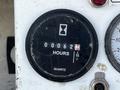 Close-up of a black hour meter with a white hourglass symbol indicating 62 hours of operation on a 2004 Freightliner M2