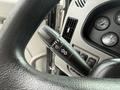 A black steering wheel with controls for lights and wipers from a 2016 Peterbilt 348 dashboard featuring various gauges and buttons