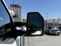 The image shows a side mirror of a 2024 Ford F-550 Super Duty reflecting a view of the surroundings