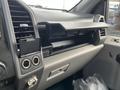 The interior of a 2017 Ford F-250 SD featuring a dashboard with air vents a glove compartment and controls for audio and climate settings