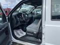 Interior of a 2015 Ford F-550 showing the driver's seat dashboard and steering wheel with a gray fabric upholstery