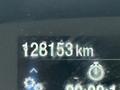 A digital display showing the distance of 128153 km on a vehicle dashboard